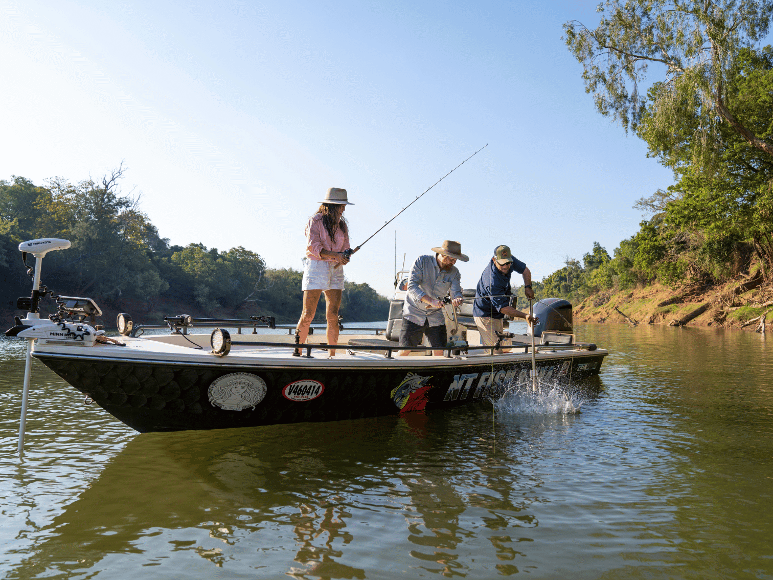 Anglers fishing from a boat on the Daly River in the Northern Territory, a popular destination for barramundi fishing.